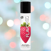A cylindrical bottle of Wet "Sexy Strawberry" Flavored Lubricant 🍓 showcases a prominent strawberry design alongside the word "FLAVORED" on its label. This silicone-safe lubricant stands out against a backdrop of soft, colorful lights.